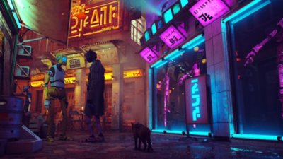 Stray - captura de ecrã que mostra um gato a caminhar por uma rua iluminada a néon