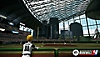 Super Mega Baseball 4-skærmbillede med en spiller, der ser på banen i et kæmpe bystadion med vinduer
