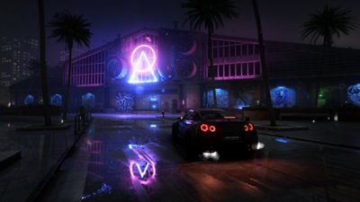 Test Drive Unlimited Solar Crown screenshot showing a car at night illuminated by a neon purple sign