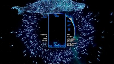 Captura de ecrã de Tetris Effect: Connected que mostra o jogo, rodeado de um cardume de peixes néon e uma baleia