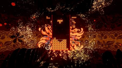 Tetris Effect Connected screenshot showing the game being played against an ornate, flower-patterned backdrop