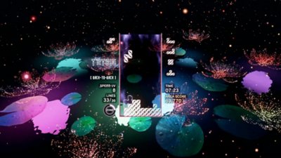Tetris Effect Connected screenshot showing the game being played against a backdrop of multi-coloured lilypads