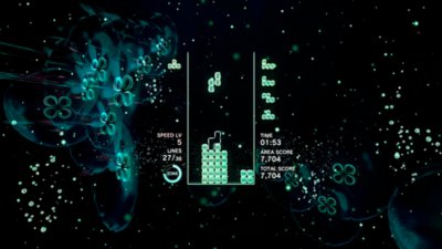 Captura de pantalla de Tetris Effect Connected que muestra el juego que se está jugando contra un fondo de medusas luminosas verdes