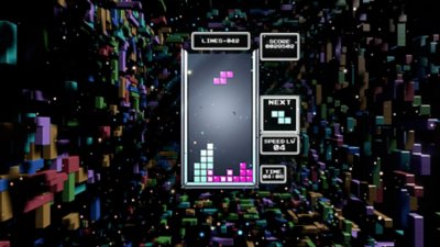 لقطة شاشة من Tetris Effect Connected تظهر بها اللعبة بمظهر كلاسيكي لألعاب Tetris في تجربة لعب مع خلفية من قطع التيترومينو الرباعية ثلاثية الأبعاد 