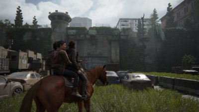 The Last of Us Part 2 screenshot showing Ellie and Dina on horseback in Seattle