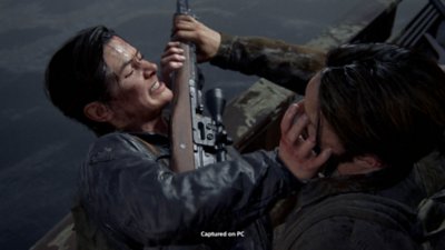 The Last of Us Part II Remastered for PC screenshot showing Abby fighting off an assailant who is holding a rifle to her throat