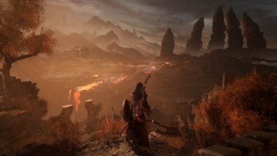 Snímek obrazovky ze hry Lords of the Fallen zobrazující hrdinu, který se dívá na pouštní krajinu s kamennými prstovými útvary v dálce