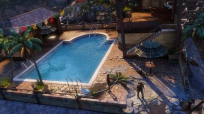 لقطة شاشة من مجموعة uncharted "ناثان دريك" تعرض مسبحًا في قصر مدمر حيث يقف "ناثان" بين الحطام