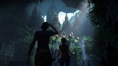 لقطة شاشة من uncharted the lost legacy تعرض "نادين" (على اليسار) و"كلوي" (على اليمين) ينظران إلى مدينة داخل كهف عملاق به أبراج ذهبية وشلالات