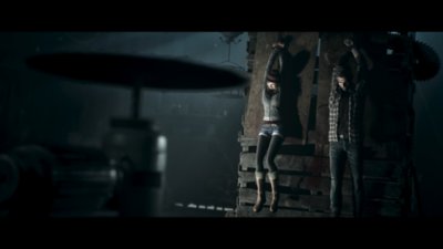 Snímek obrazovky ze hry Until Dawn, na kterém postava v temné jeskyni drží pochodeň