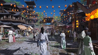 Where Winds Meet screenshot showing the player character walking on a crowded street with lanterns strung above