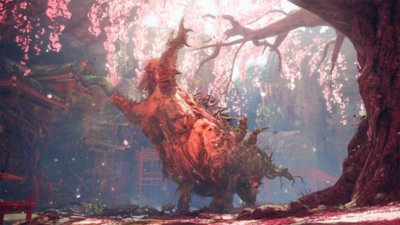 Captura de pantalla de Wild Hearts que muestra una criatura gigante rugiendo debajo de los cerezos en flor