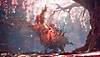 Istantanea della schermata di Wild Hearts che mostra una creatura gigante che ruggisce sotto gli alberi di ciliegio