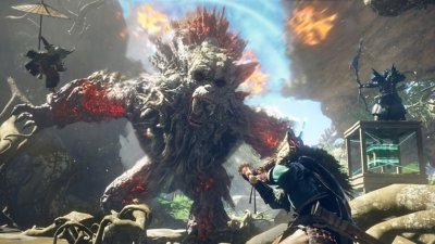 Captura de pantalla de WILD HEARTS que muestra a un personaje luchando contra una bestia de gigante
