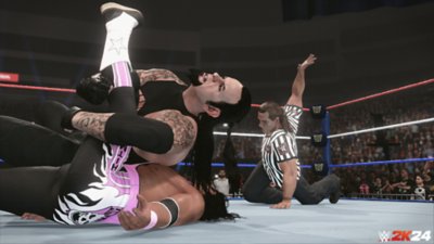 WWE 2K24 – snímek obrazovky zobrazující režim Guest Referee v zápase s The Undertakerem